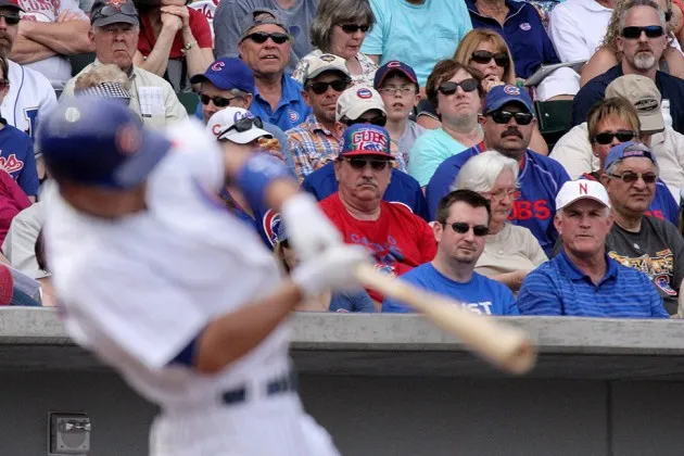 Chicago Cubs second baseman Darwin Barney swings while Cubs fans watch during the spring training game between the Seattle Mariners and the Chicago Cubs at Cubs Field in Mesa, Arizona on March 20