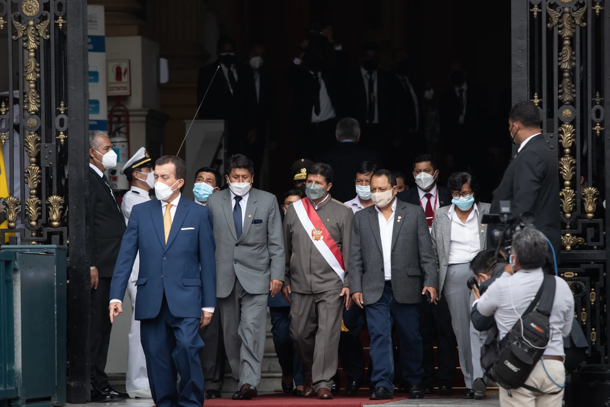 Pedro Castillo, center, leaves for an impeachment hearing on March 28.