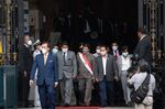 Pedro Castillo, center, leaves for an impeachment hearing on March 28.