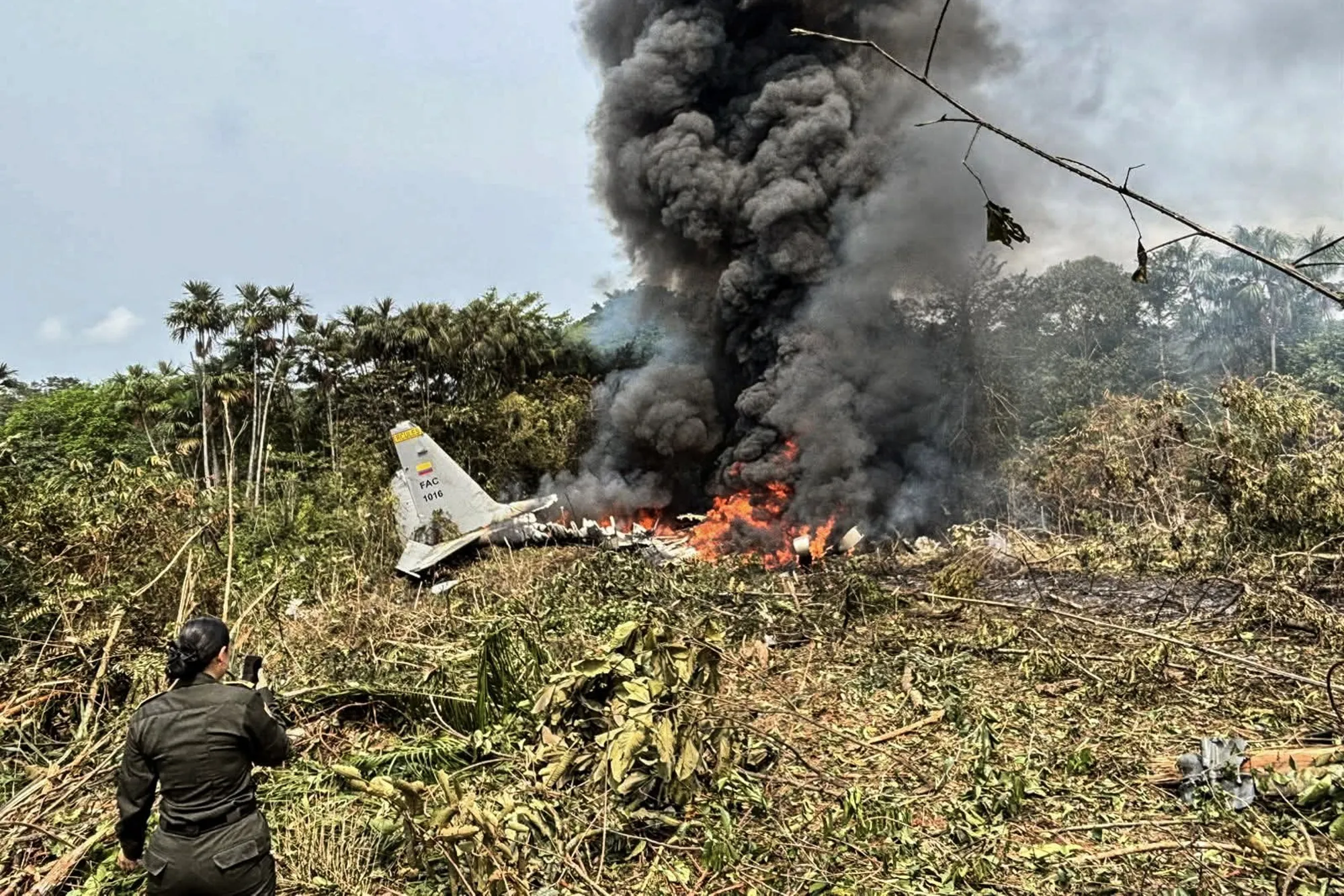 Smoke rises from an Air Force Hercules that crashed during takeoff in Puerto Leguizamo, Colombia, on March 23.