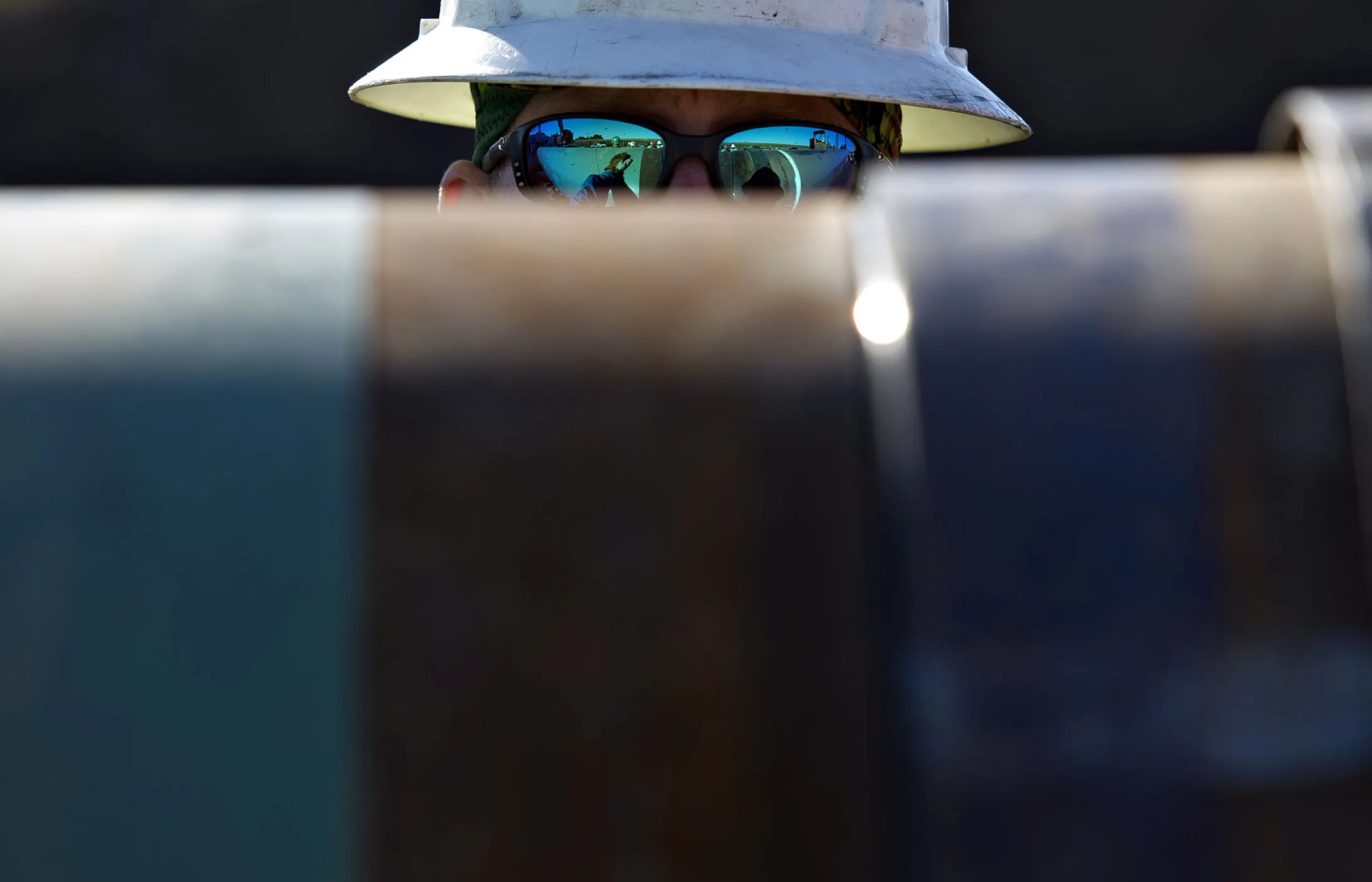 A Michels Corp. contractor watches as two sections of pipe are prepped for welding during construction of the Flanagan South crude oil pipeline outside Goodfield, Illinois, U.S., on Tuesday, Oct. 8, 2013. The approximately 600-mile, 36-inch crude oil pipeline is being constructed by Enbridge Energy Co., a subsidiary of Enbridge Inc., Canada's largest oil transporter, and will originate in Flanagan, Illinois and terminate in Cushing, Oklahoma.
