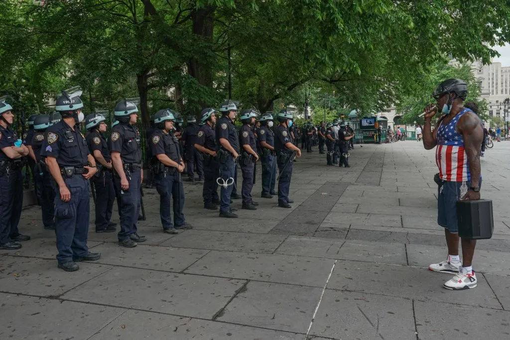 A man speaks to members&nbsp;of the New York City Police Department at a demonstration in City Hall Park during a protest against police brutality and racism, on June 6, 2020, in New York.&nbsp;