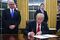 US President Donald Trump signs an executive order as Vice President Mike Pence looks on at the White House in Washington, DC on January 20, 2017. / AFP / JIM WATSON        (Photo credit should read JIM WATSON/AFP/Getty Images)
