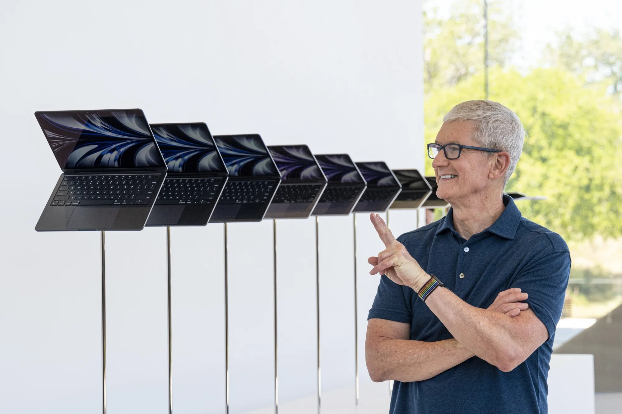 Apple CEO Tim Cook and&nbsp;a&nbsp;display of MacBook Air laptops&nbsp;during a developers conference in June in Cupertino, California.