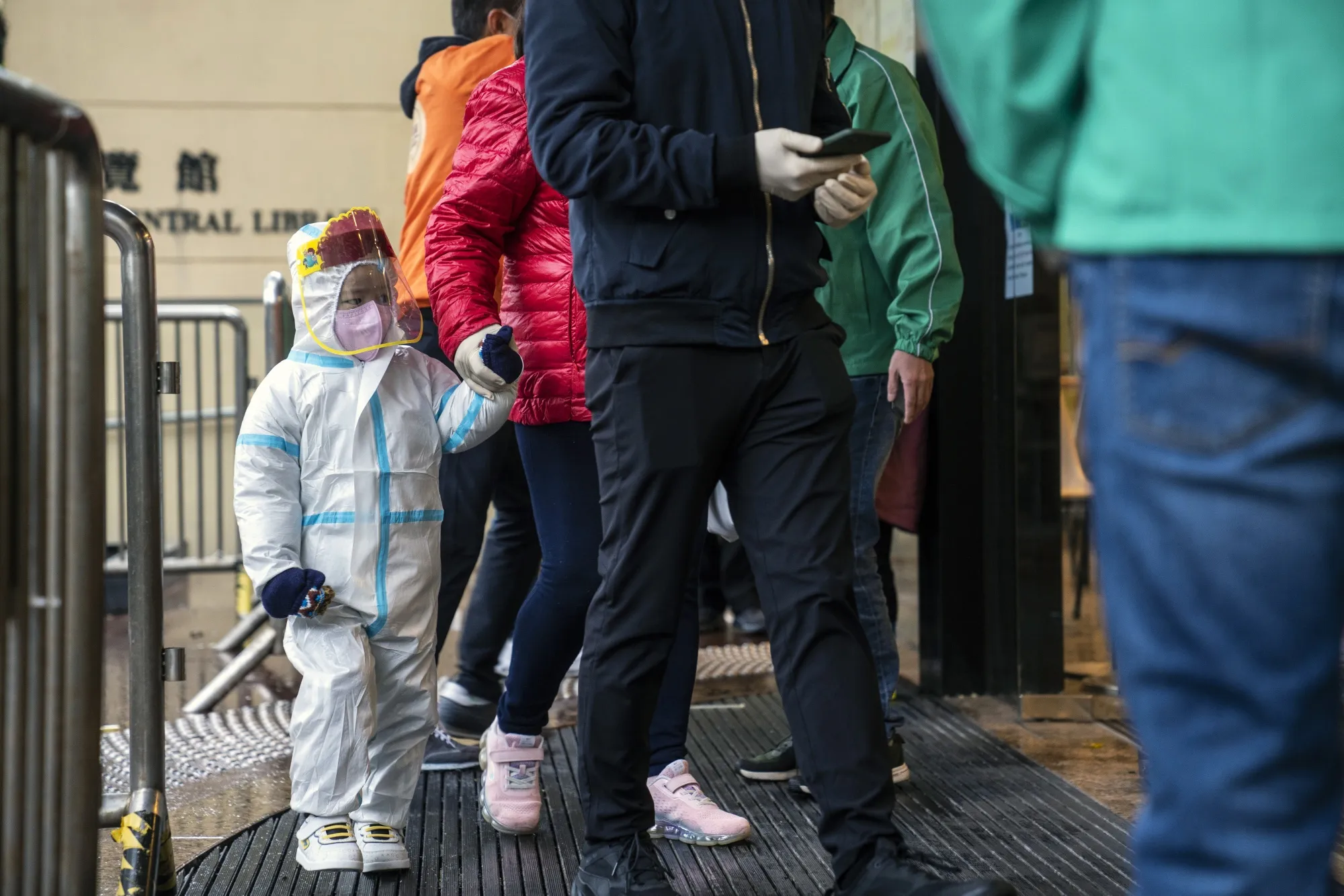 A child enters a community vaccination center&nbsp;in Hong Kong in February.