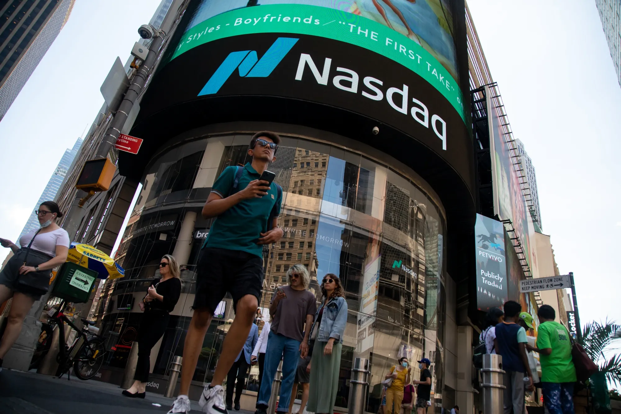 Pedestrians in front of the Nasdaq MarketSite in New York.&nbsp;