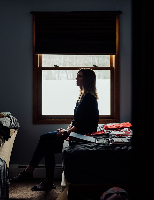 Jennifer Buta sits at the edge of her son Jordan DeMay’s bed inside her home.