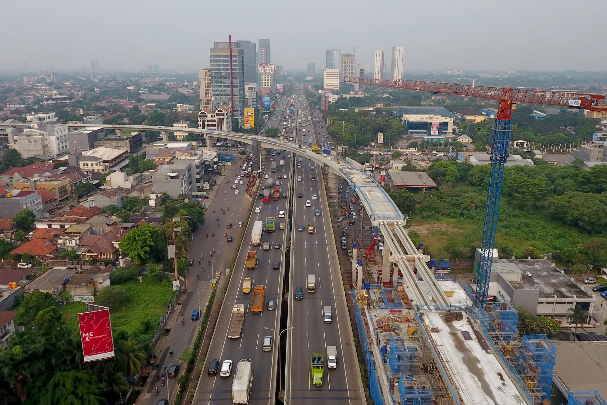 An elevated track for the Jakarta Mass Rapid Transit (MRT) stands under construction as vehicles travel along a highway in this aerial photograph taken in Jakarta, Indonesia, on Sunday, Aug. 13, 2017. President Joko Widodo is seeking hundreds of billions of dollars to finance an ambitious infrastructure agenda and to boost growth to 7 percent.