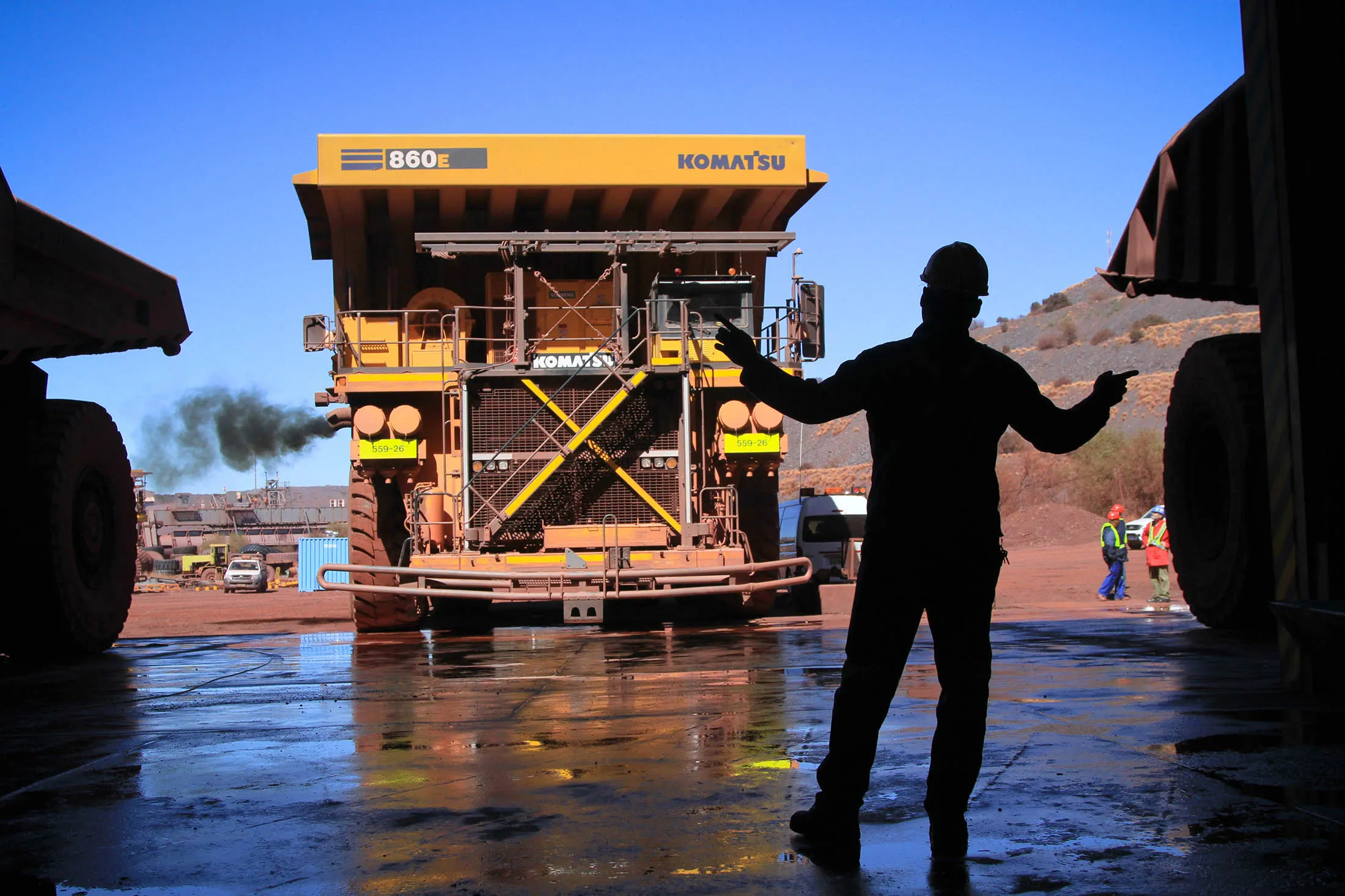 An employee guides a haul truck into service at the Sishen open cast mine in South Africa.
