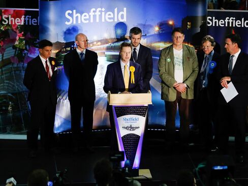 Nick Clegg, leader of the Liberal Democrats, stands at the podium and speaks from the count at the English Institute of Sport after retaining his constituency seat for Sheffield Hallam in Sheffield, U.K.