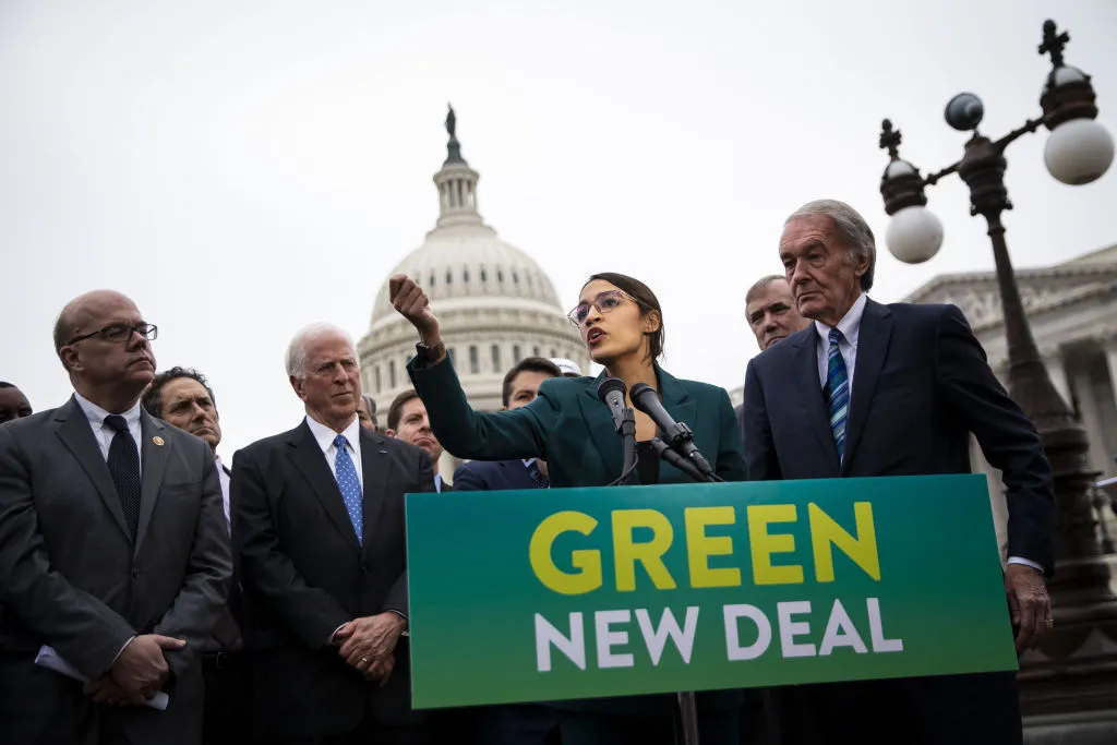Representative Alexandria Ocasio-Cortez, a Democrat from New York, speaks as Senator Ed Markey, a Democrat from Massachusetts, right, listens during a news conference announcing Green New Deal legislation in Washington.