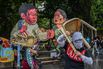 Masked protesters act in front of the effigy of President