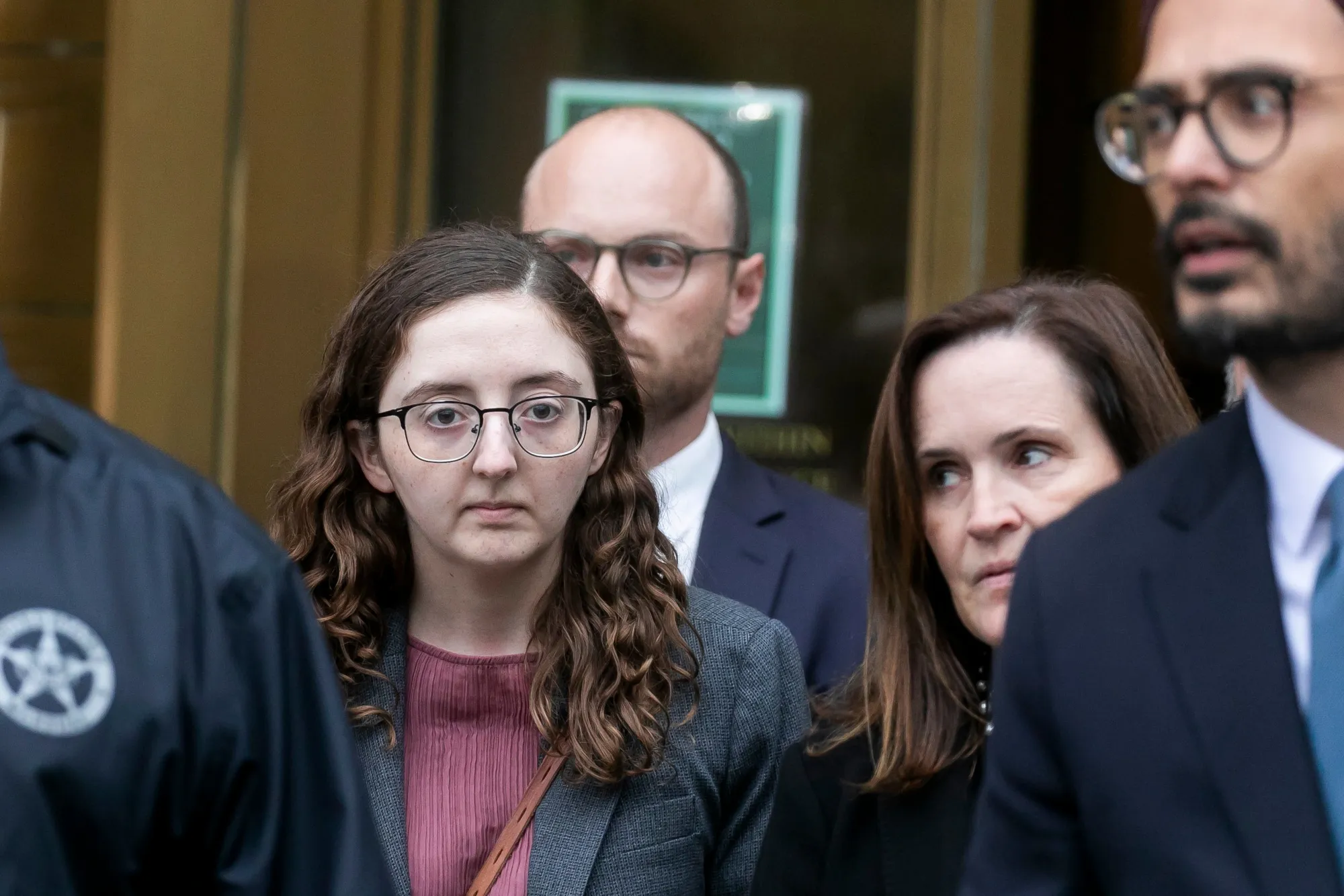 Caroline Ellison, former chief executive officer of Alameda Research LLC, center left, exits court in New York, in 2024 after sentencing.