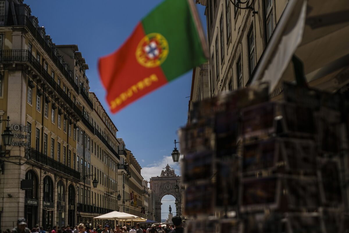 Members of the Portuguese Communist Party Youth carry flags and