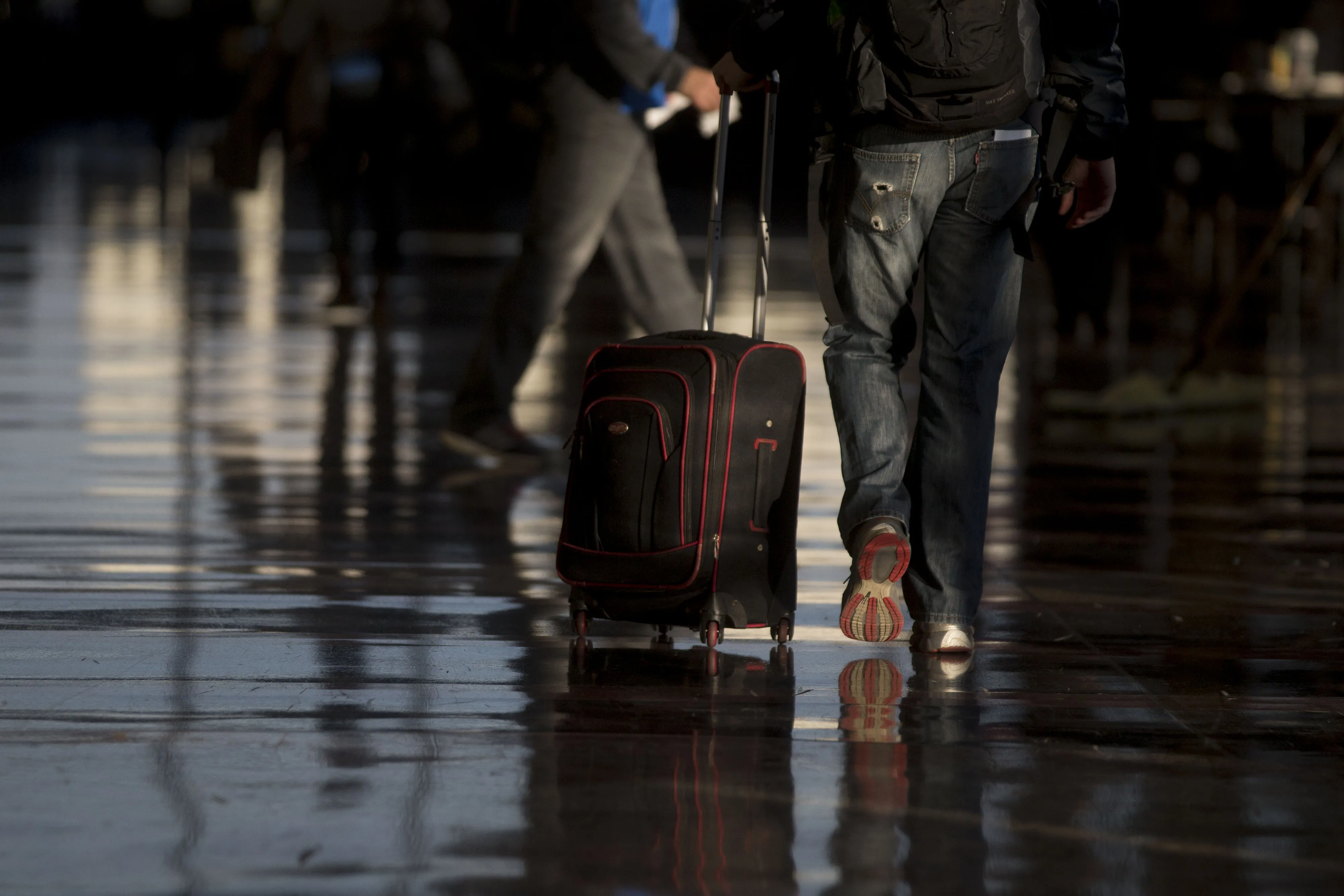 A traveler pulls a suitcase through Ronald Reagan National airport (DCA) in Washington, D.C.