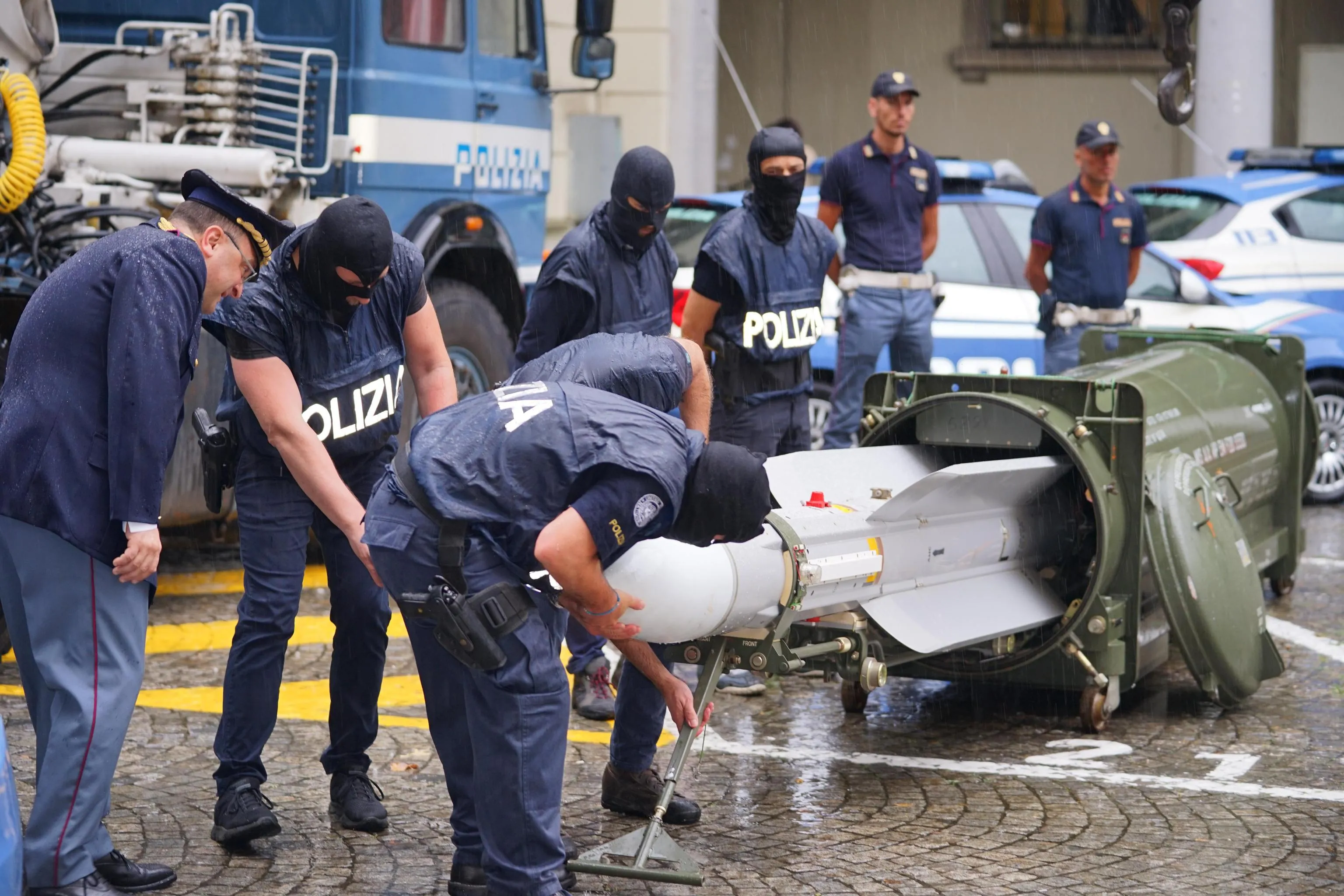 Anti-terrorist police inspect an air-to-air missile in Turin on July 15.