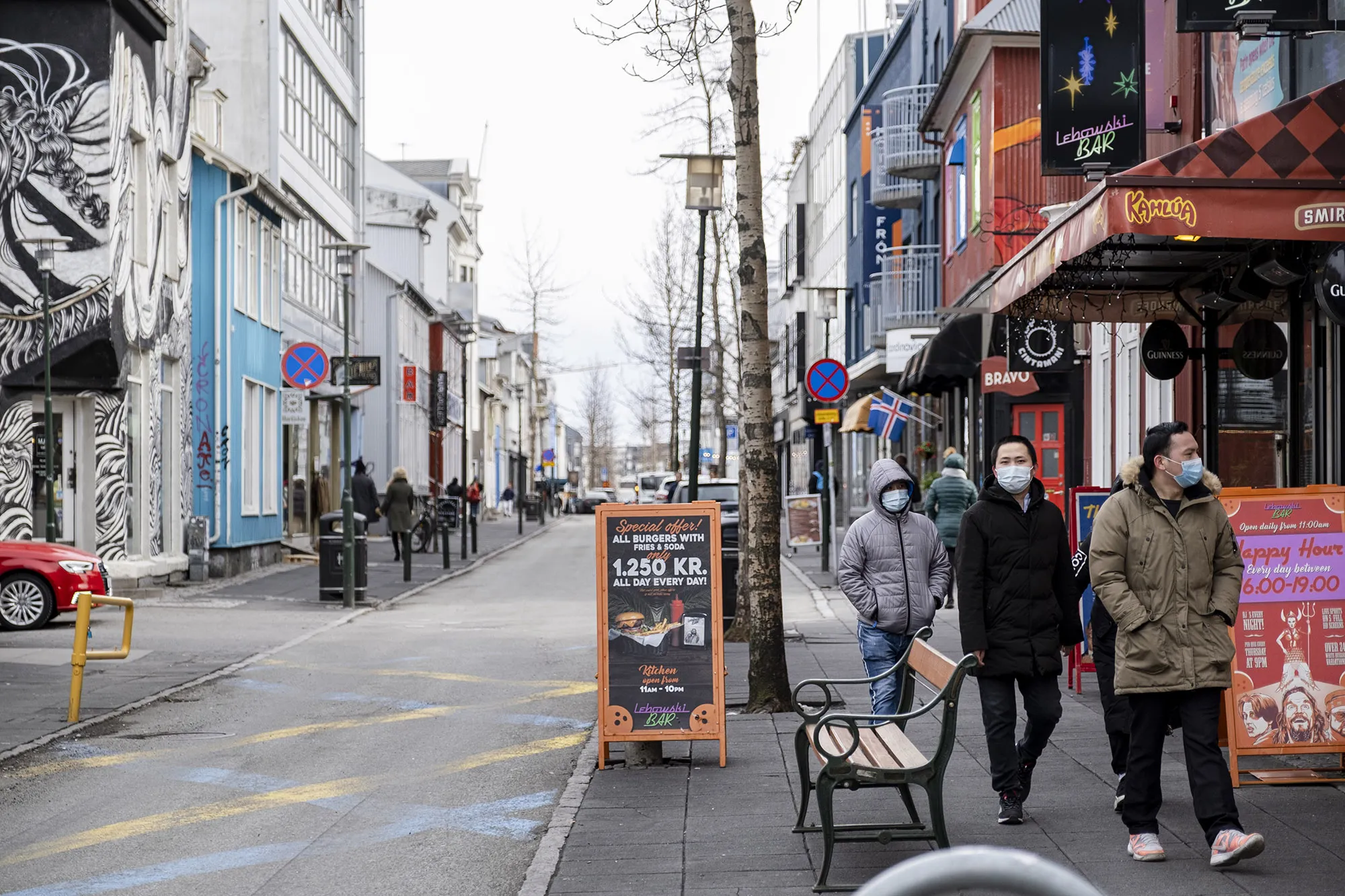 People walk down Laugavegur street in downtown Reykjavik.