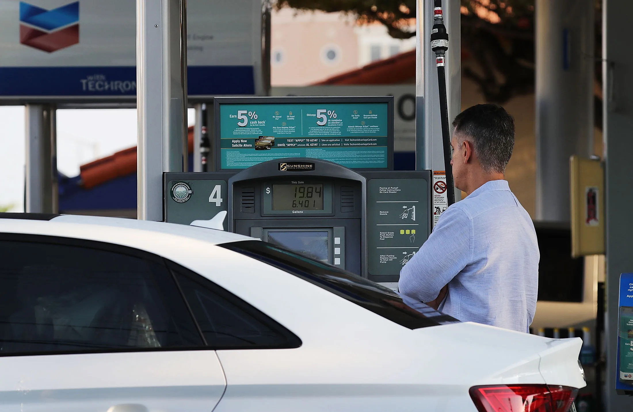 A customer pumps gas into a vehicle as reports indicate that the price of gasoline continues to rise, in Miami.&nbsp;