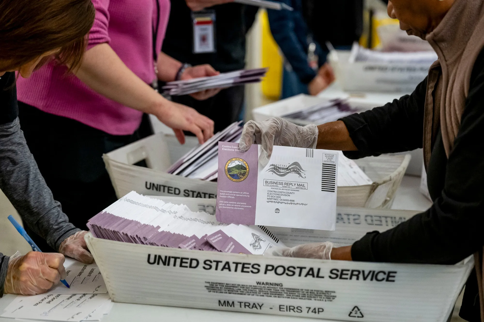 Election workers sort mail-in ballots in Martinez, California, in 2024.