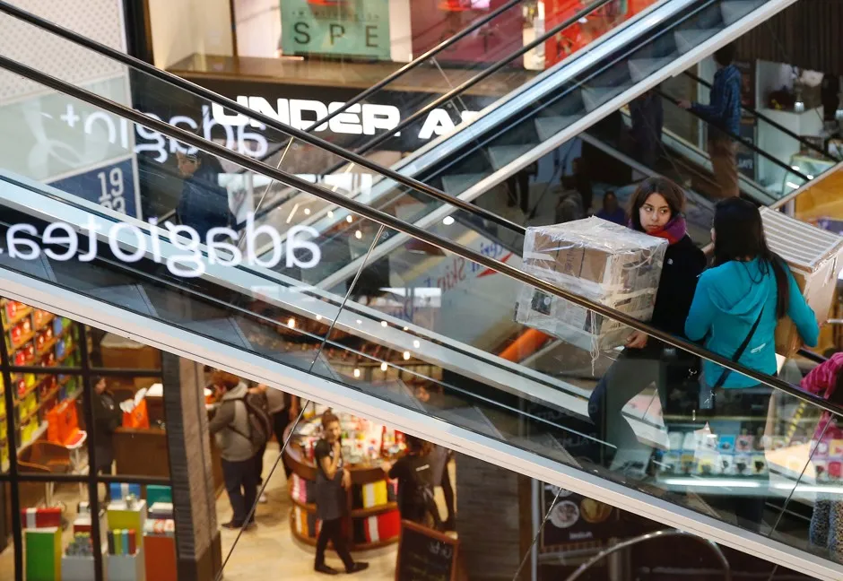 Shoppers ride escalators inside a mall in Vina del mar, Chile. 