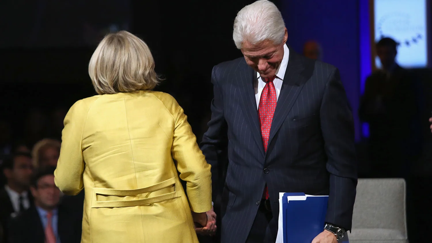 Former U.S. President Bill Clinton and Secretary of State Hillary Clinton clasp hands as Hillary prepares to speak at the closing session of the Clinton Global Initiative (CGI), on September 24, 2014 in New York City.
