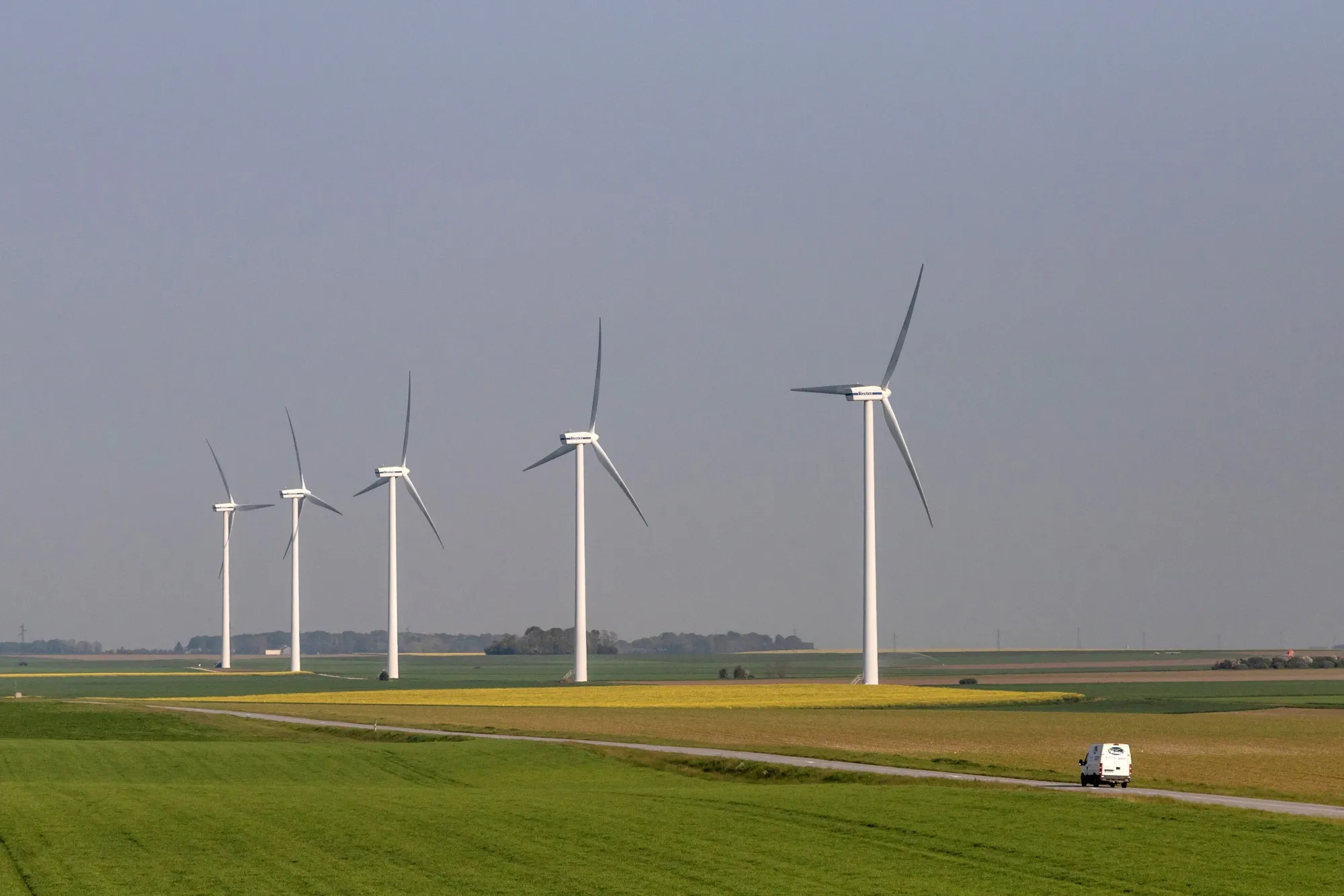 Wind turbines in fields of canola in Sermaises, France.