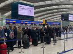 Travelers queue to check-in at Terminal 5 at Heathrow Airport in London on April 4.