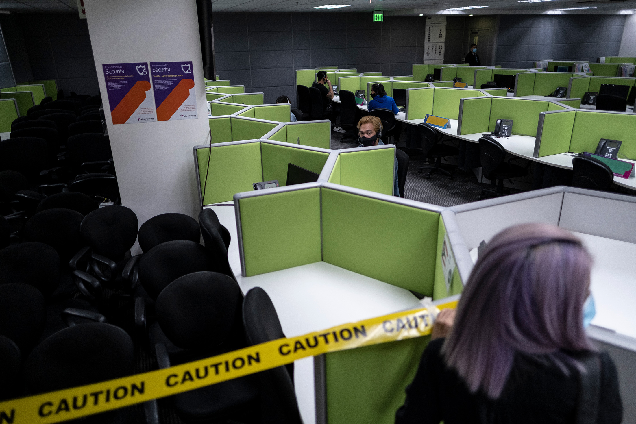 Safety tape is placed across work areas at a call center in Manila on June 8.
