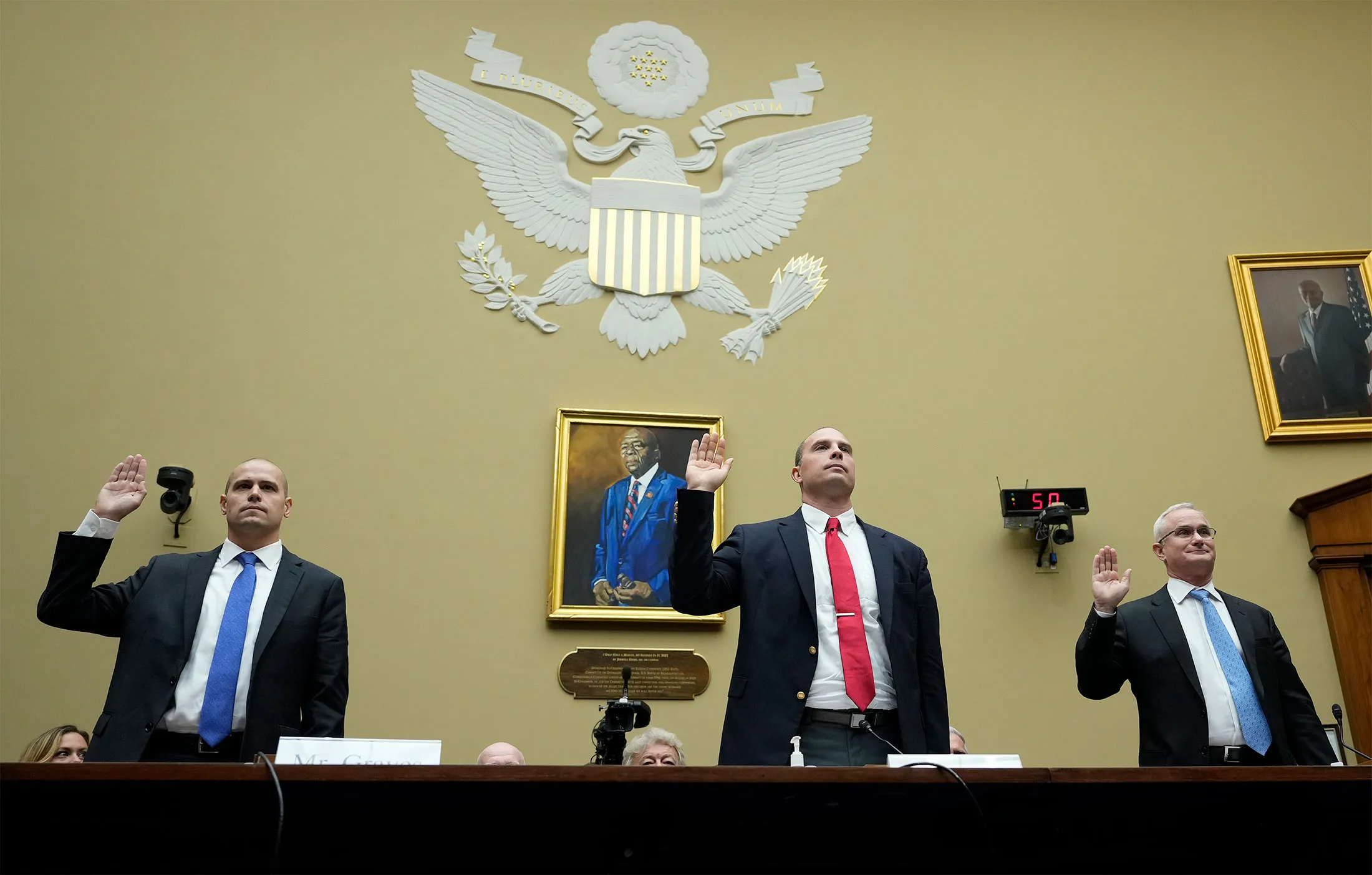 Ryan Graves, from left, David Grusch and David Fravor are sworn-in during a House hearing in Washington, DC, on Wednesday.