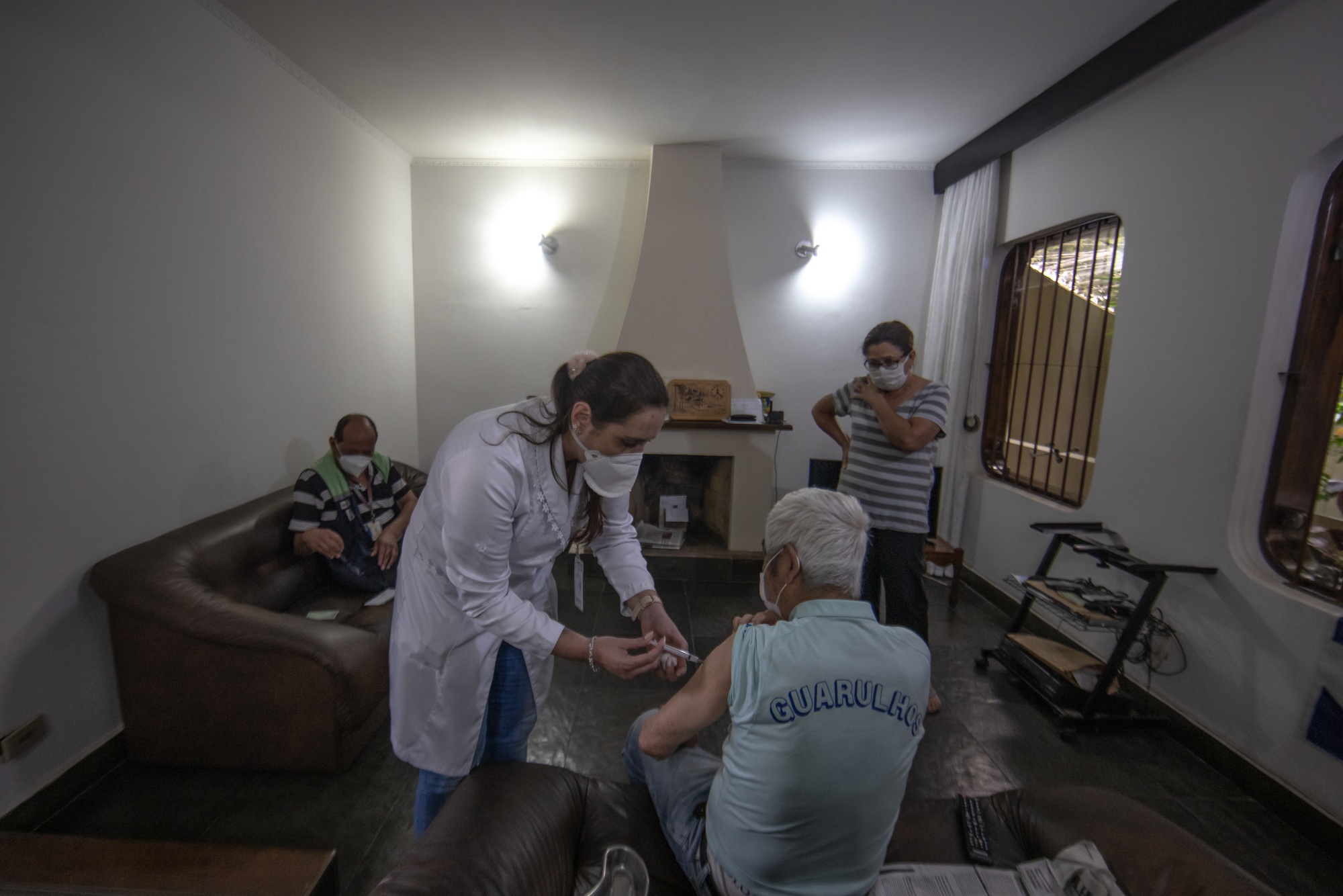 A healthcare worker administers the Sinovac Biotech Ltd. Covid-19 vaccine to an elderly resident in Sao Paulo, Brazil, on&nbsp;Feb. 12.