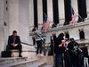 People walk past the New York Stock Exchange.