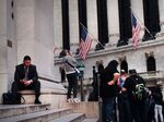 People walk past the New York Stock Exchange.