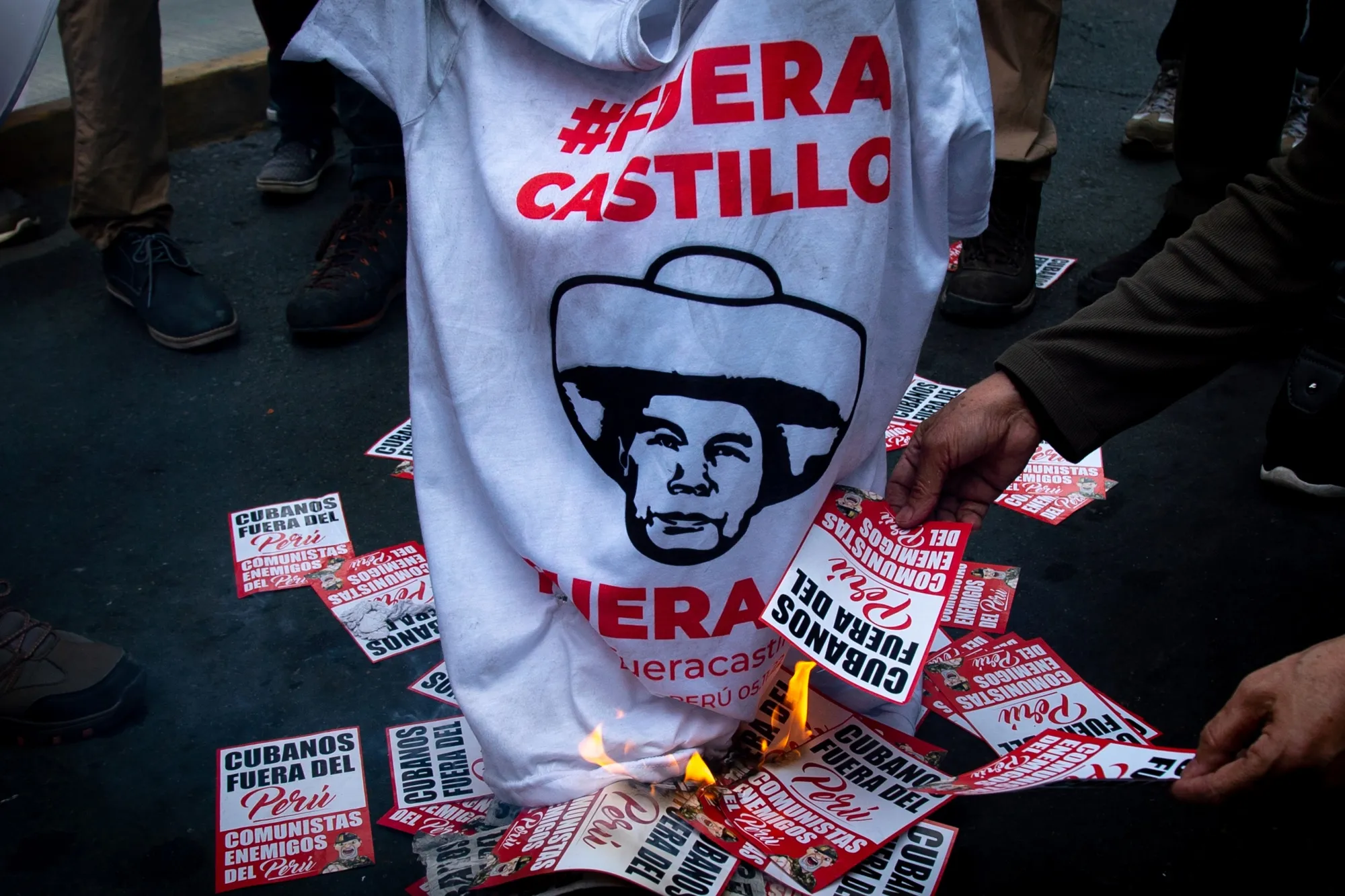 Demonstrators protest against Pedro Castillo, Peru's former president, following his impeachment and arrest, near the Lima Prefecture in Lima, Peru, on&nbsp;Dec. 7.