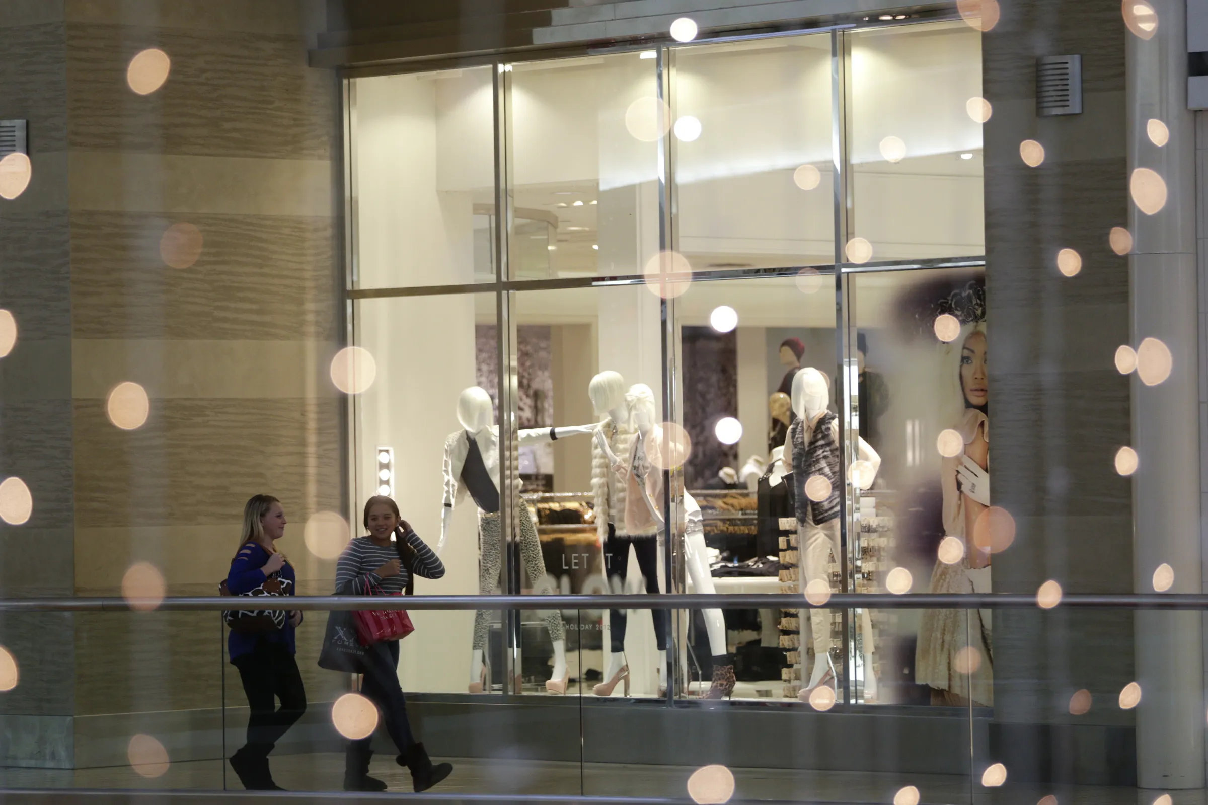 Shoppers walk past a Forever 21 Inc. store in Fairfax, Virginia.