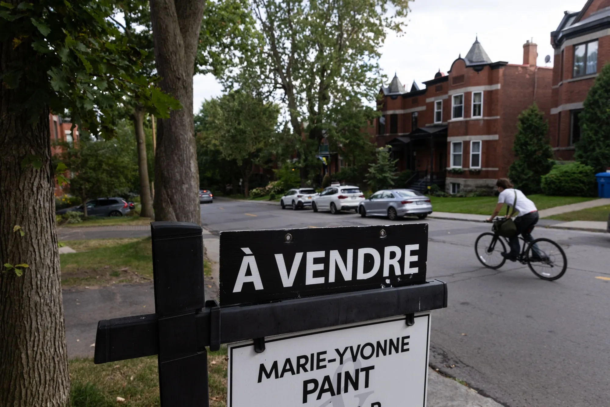 A "For Sale" sign outside a house in Montreal, Quebec, Canada.
