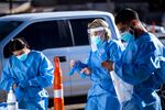 Medical workers put on PPE before starting shifts at a Covid-19 drive-thru testing site in El Paso, Texas, on&nbsp;Nov. 9.&nbsp;