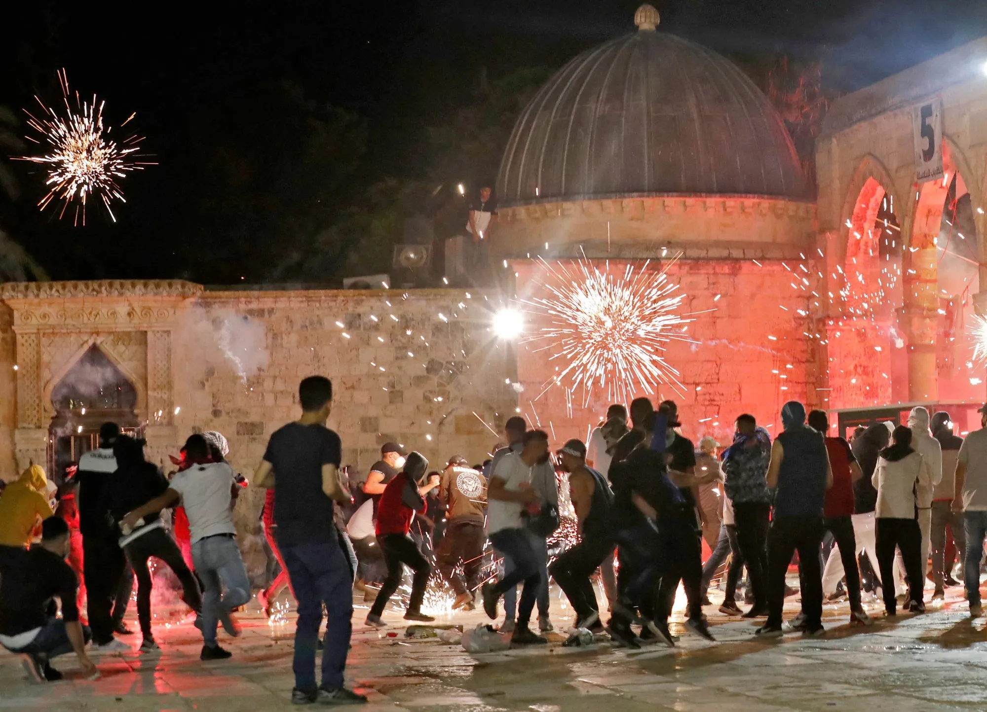 Stun grenades burst in the air amid clashes between Palestinian protesters and Israeli security forces at the al-Aqsa mosque compound in Jerusalem, on May 7. (