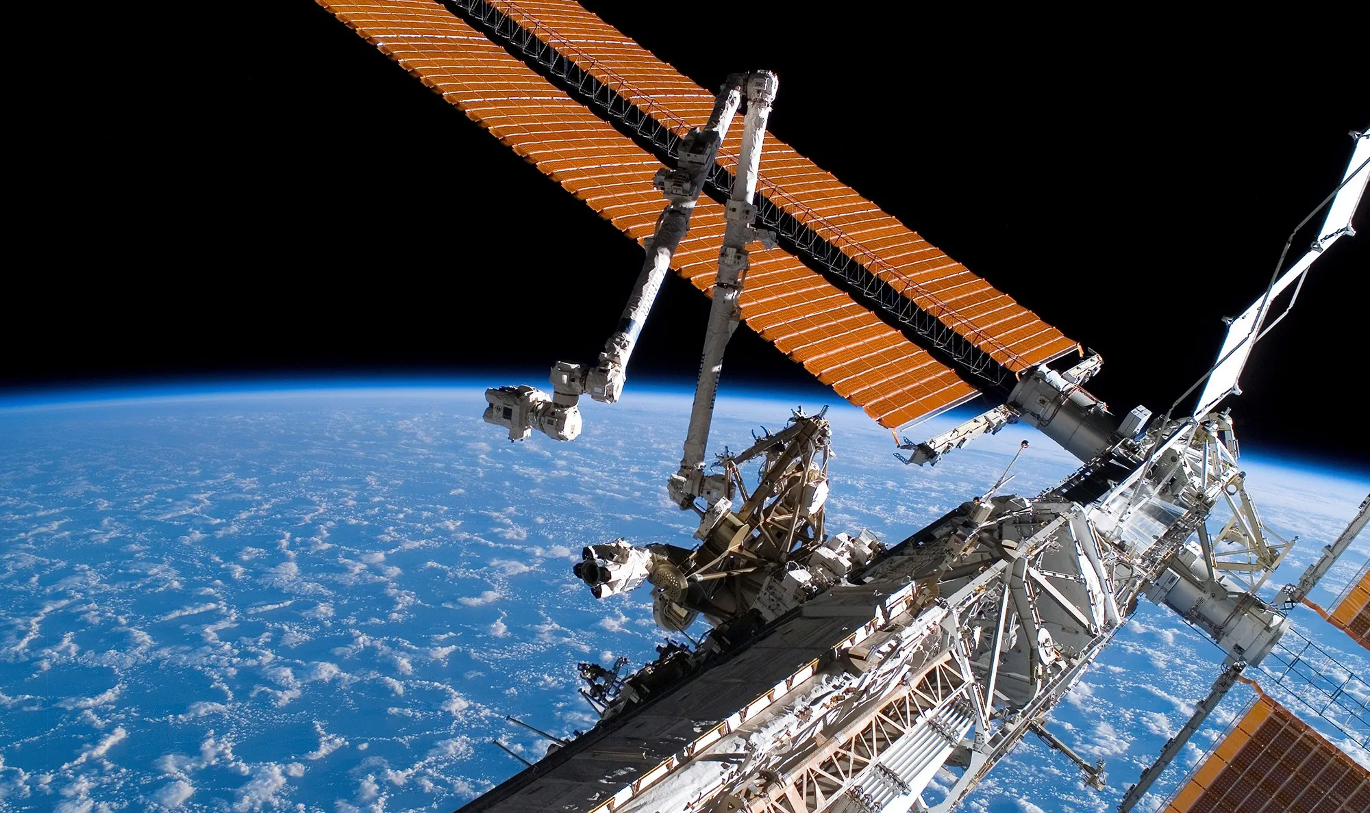 In this photo provided by NASA, the Canadarm2 and solar array panel wings on the International Space Station are extended during a 2007 mission.