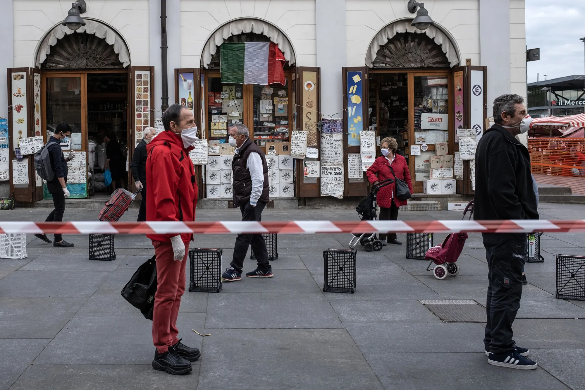 People wait in line at a safe&nbsp;distance to shop at the food market of Porta Palazzo in Turin on May 4.