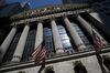 American flags are displayed outside the New York Stock Exchange (NYSE) in New York, U.S., on Friday, July 8, 2016. U.S. stocks rallied to erase losses sparked by Britain's vote to exit the European Union, as stronger payroll growth calmed concerns that slowing momentum in the job market would weigh on the economy.