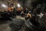 Indian laborers work at a nail production unit in Tripura, India, on June 4, 2013