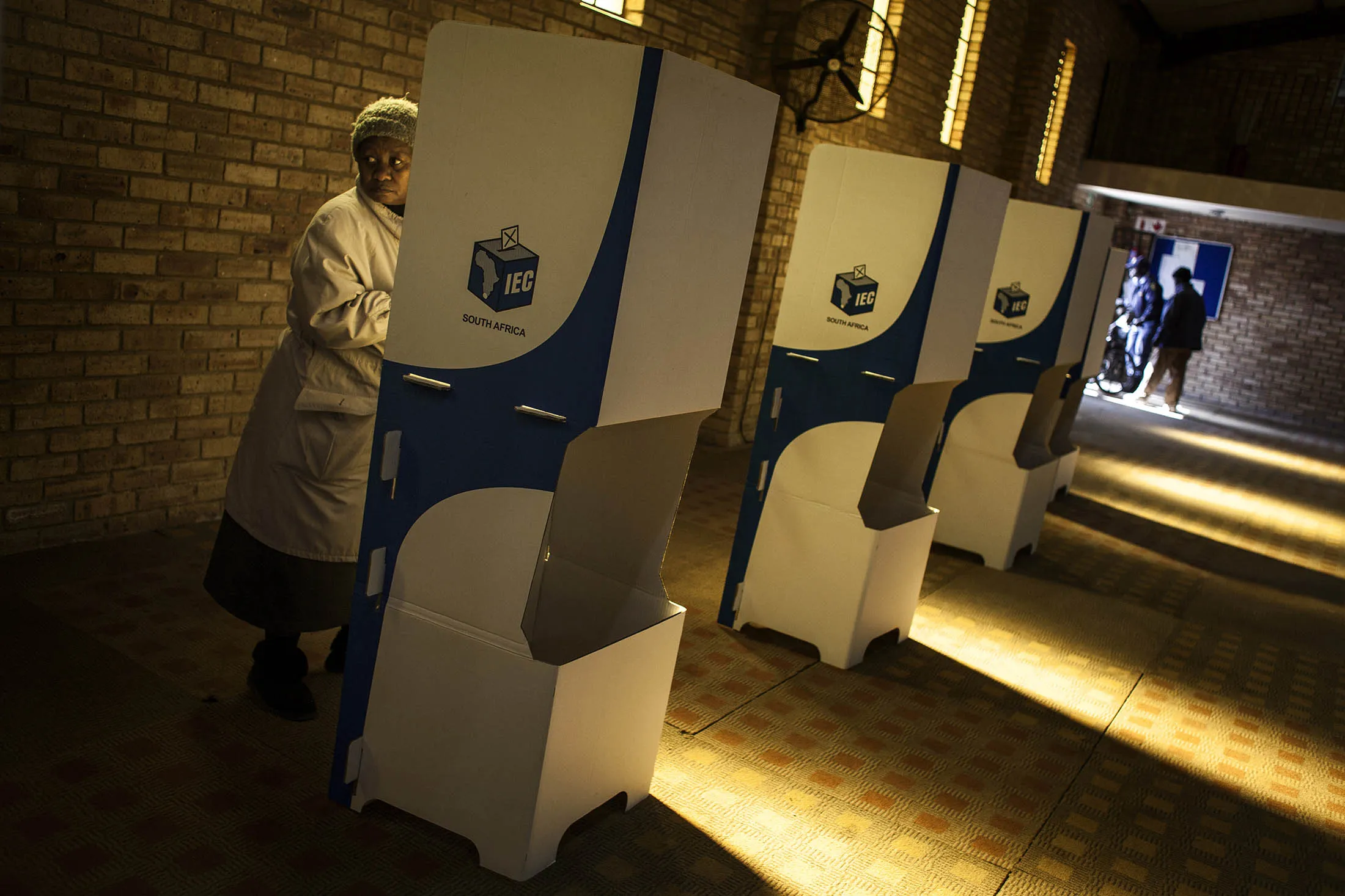 A woman marks her ballot paper in a voting booth during municipal elections at a polling station in Soweto's Freedom Park, South Africa, on Aug. 3.
