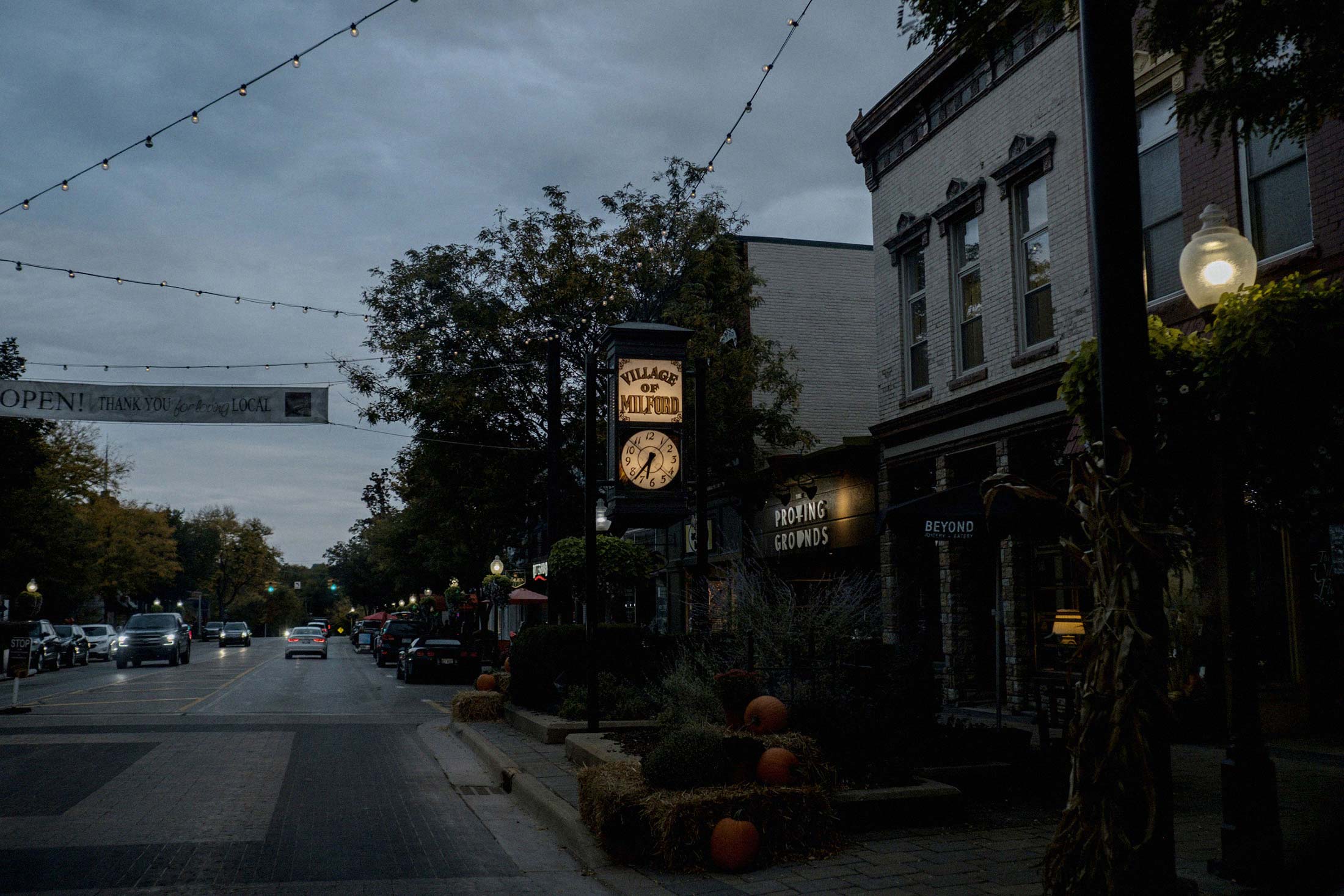 The Village of Milford clock lights up as the sun sets in downtown Milford, Mich.