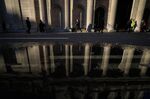 Pedestrians walk past the Bank of England (BOE) in the City of London.