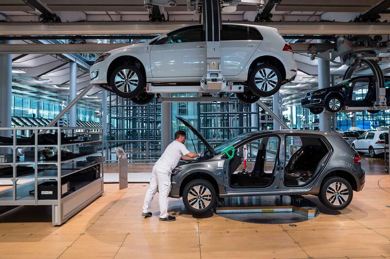 Volkswagen workers build a Golf electric car at a factory in Dresden.