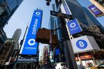 Monitors display Coinbase signage during the company's initial public offering (IPO) at the Nasdaq MarketSite in New York, U.S., on Wednesday, April 14, 2021. Coinbase Global Inc., the largest U.S. cryptocurrency exchange, is set to debut on Wednesday through a direct listing, an alternative to a traditional initial public offering that has only been deployed a handful of times.