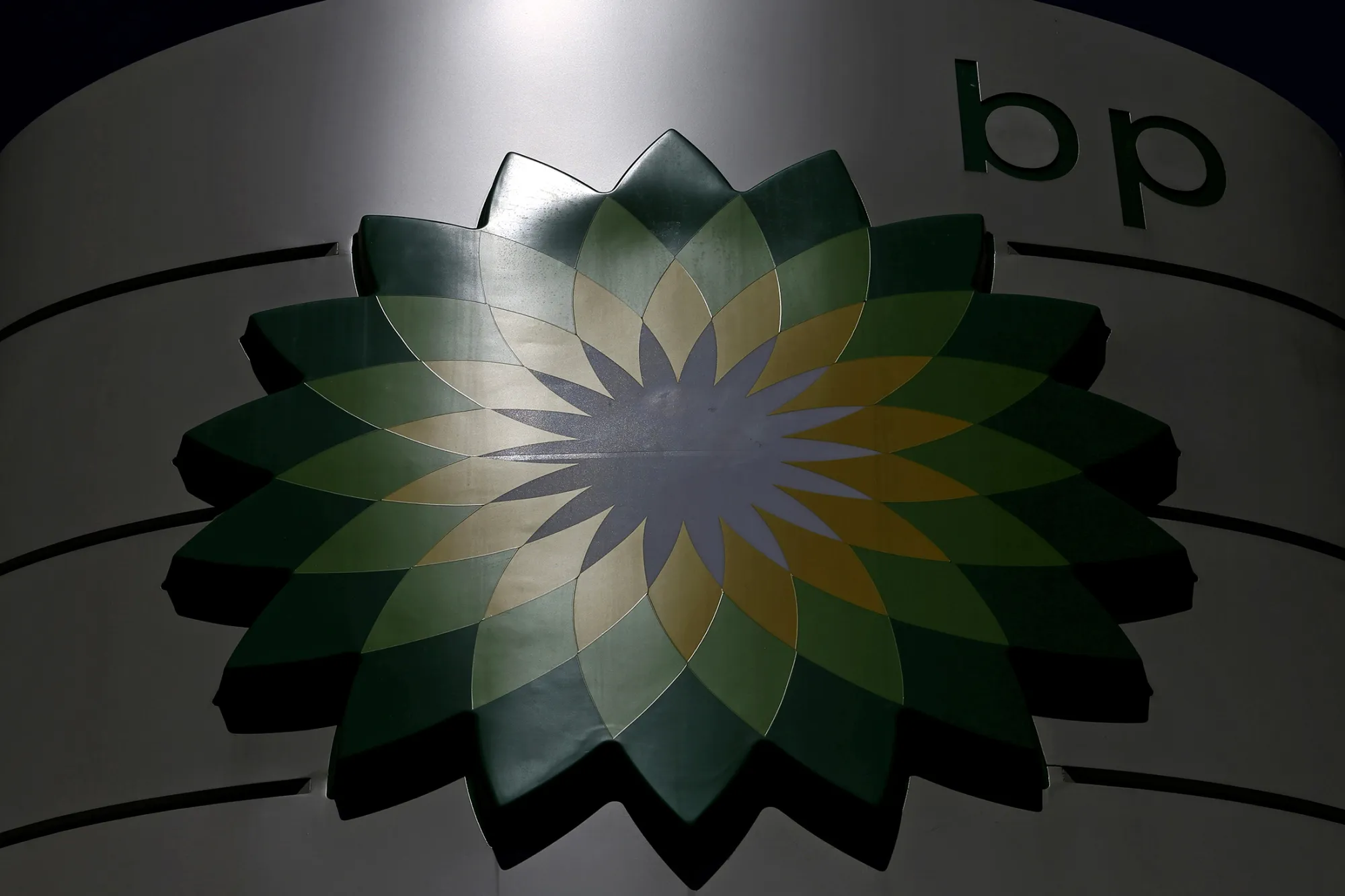A BP company logo is displayed on the forecourt of a gas station operated by BP Plc in London, U.K., on Tuesday, June 4, 2013. Royal Dutch Shell Plc, BP Plc, Statoil ASA and Platts, the oil-price data collector owned by McGraw Hill Financial Inc., said they're being investigated after the European Commission conducted raids in three countries to ferret out evidence of collusion.
