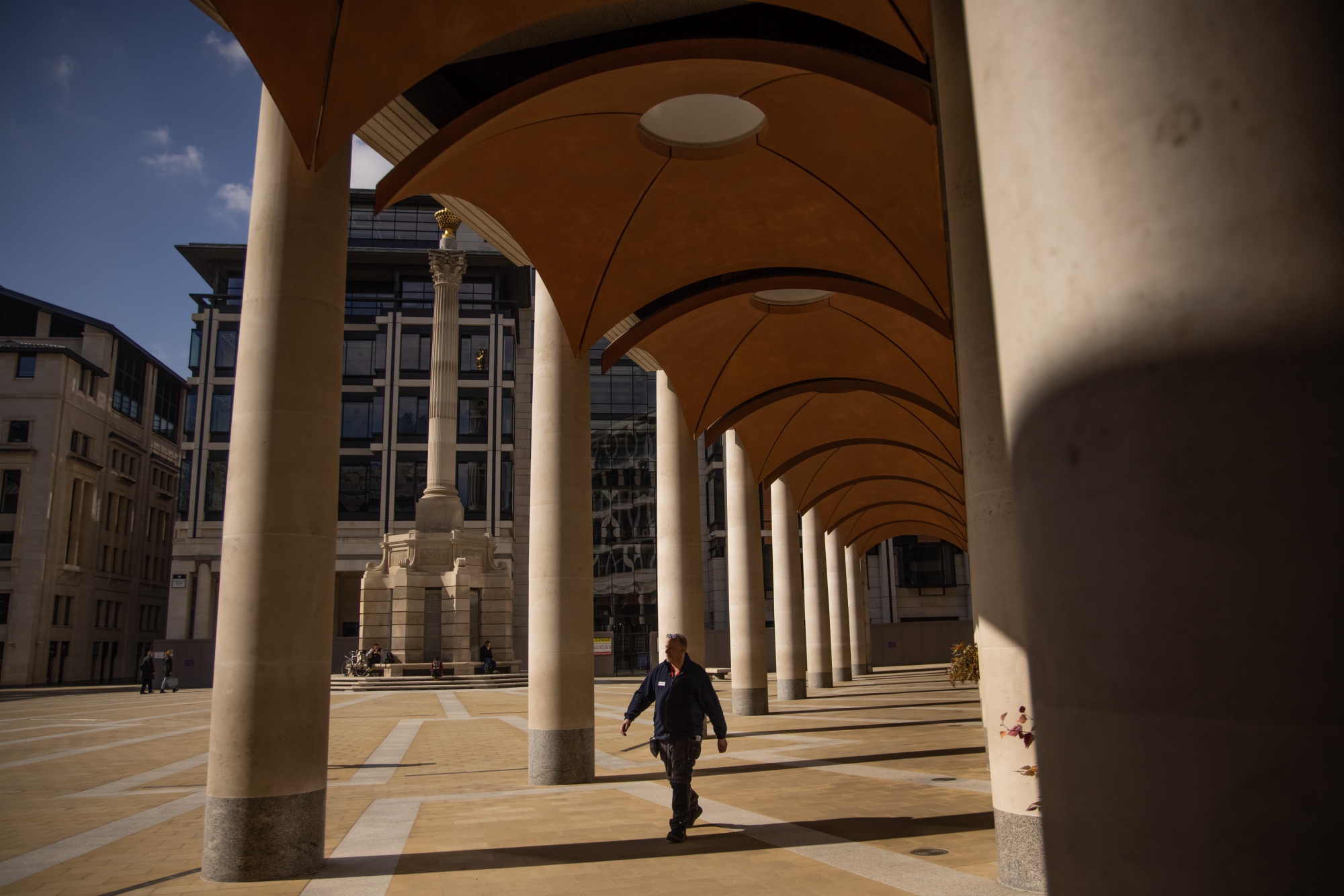 A pedestrian passes the London Stock Exchange, in the City of London.