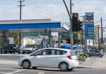 Motorists drive by a Chevron Corp. gas station in downtown Los Angeles, California, U.S.