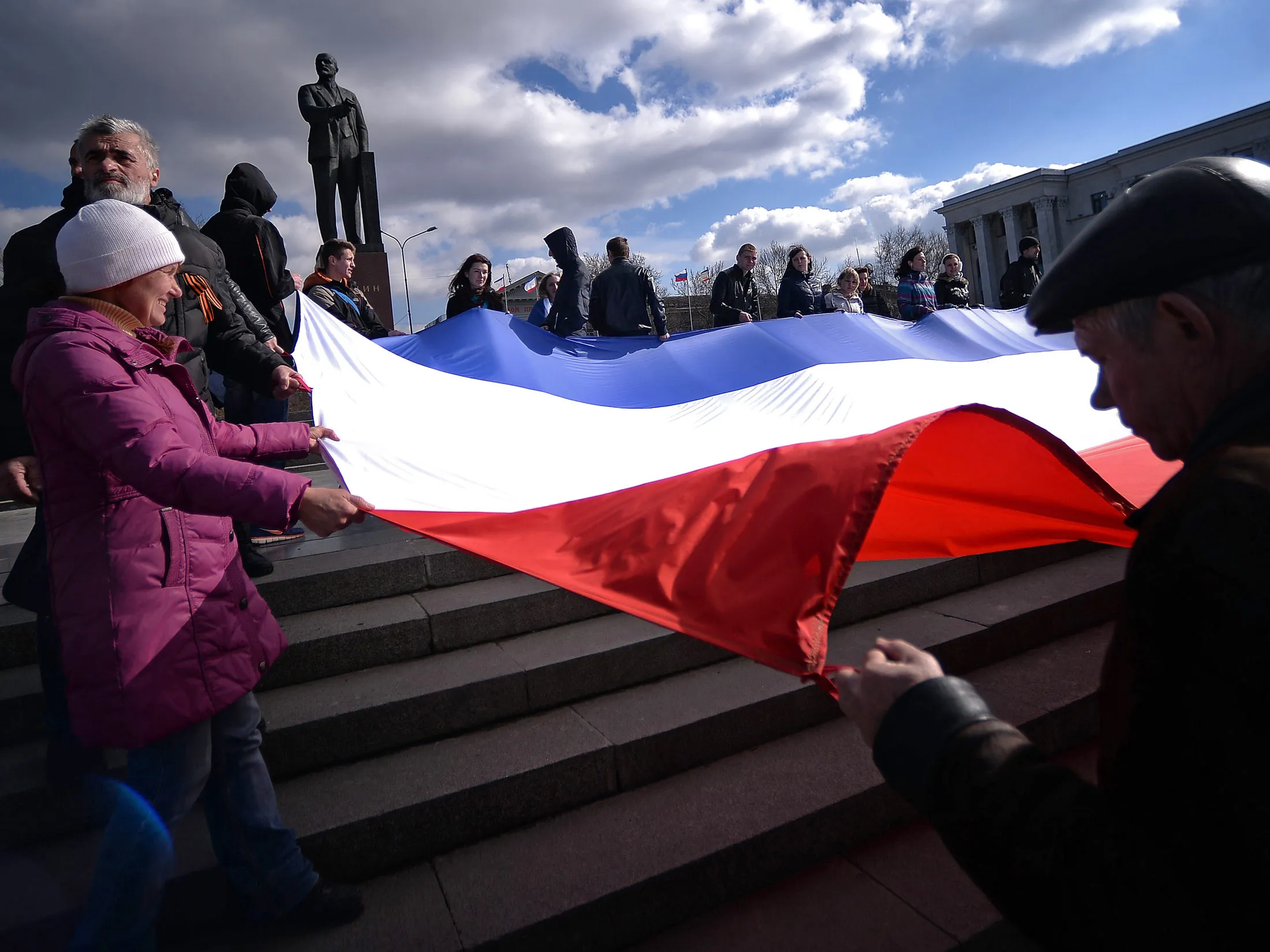 Demonstrators hold a Crimean flag at Lenin Square in Simferopol.
